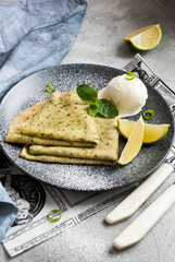 pancakes with mint, lime and scoop of ice on a plate