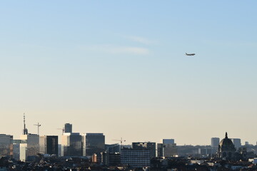 Fototapeta na wymiar A plane is flying low over a city
