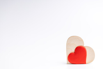 couple hearts red one and wooden over white background. love and romance concept. valentine day greeting card conceptual