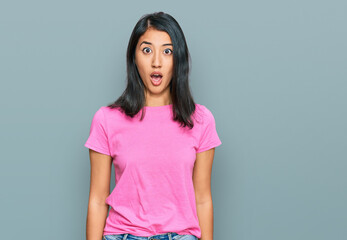 Beautiful asian young woman wearing casual pink t shirt afraid and shocked with surprise expression, fear and excited face.