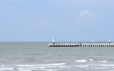Lighthouse and pier with people