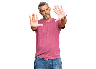 Middle age grey-haired man wearing casual clothes doing frame using hands palms and fingers, camera perspective