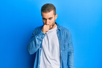 Young caucasian man wearing casual clothes feeling unwell and coughing as symptom for cold or...