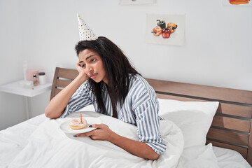 Woman staying alone at the self isolation at her birthday party