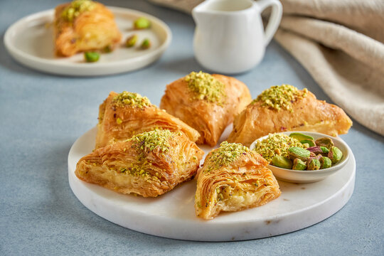 Sweets arabic dessert baklava, warbat , kunafa, kadayif with pistachio and cheese.. Close up