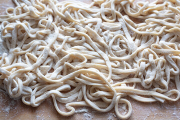 Raw fresh homemade pasta on wooden board