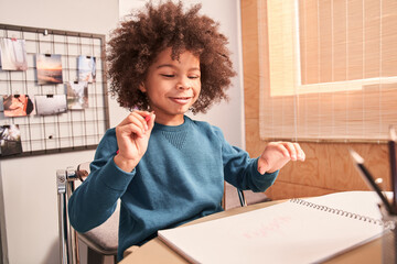 Boy studying at the kitchen during the pandemic