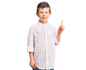 Cute blond kid wearing elegant shirt with a big smile on face, pointing with hand finger to the side looking at the camera.