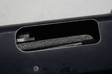 raindrops on the receiver and tray of the pump-action shotgun
