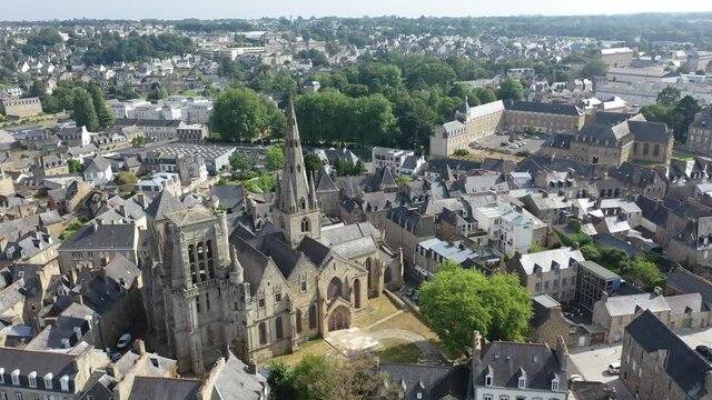 Aerial view of historic centre of Guingamp overlooking ancient Basilica of Notre Dame de Bon Secours, Brittany, France. High quality 4k footage