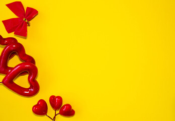 Love day congratulation. Red rose and greeting card with heart sign on yellow background top view copy space