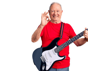 Senior handsome grey-haired man playing electric guitar doing ok sign with fingers, smiling friendly gesturing excellent symbol