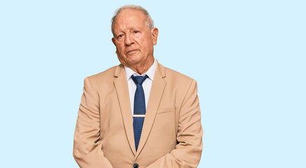 Senior caucasian man wearing business suit and tie relaxed with serious expression on face. simple and natural looking at the camera.