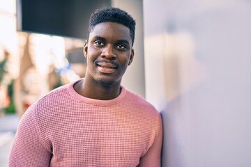 Young african american man smiling happy standing at the city.