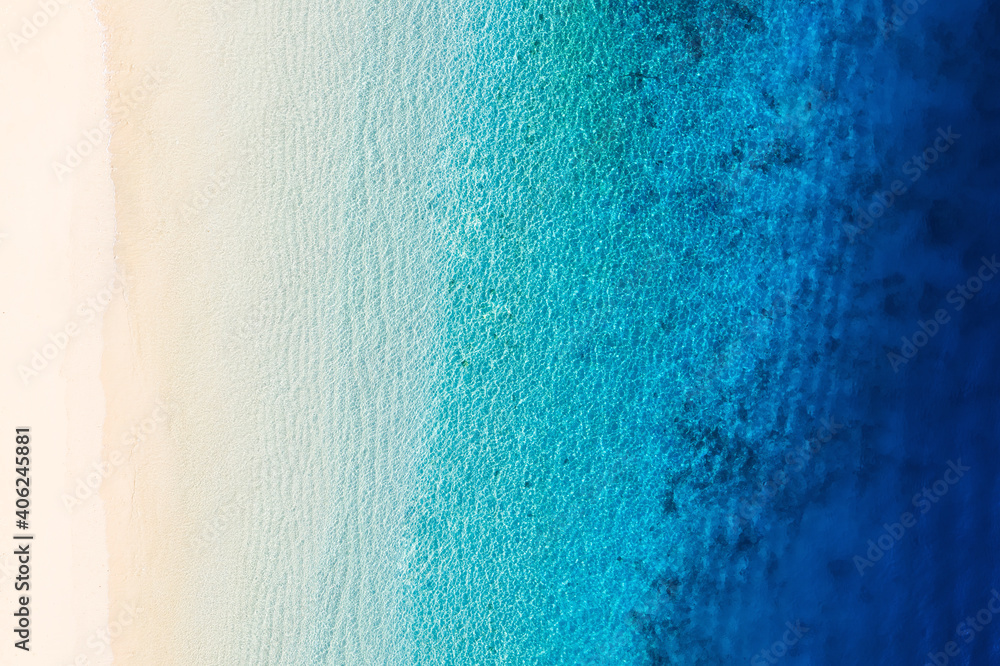 Wall mural waves as a background from top view. azure water background from drone. summer seascape from air. gi