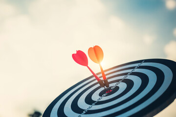 Close up shot of the dart arrow hit on bulleyes of dartboard to represent that the business reached...