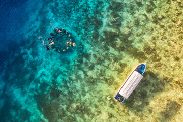 The people are snorkeling near the famous place on Gili Meno Island, Indonesia. Aerial view....