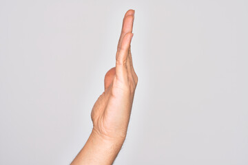 Hand of caucasian young man showing fingers over isolated white background showing side of stretched hand, pushing and doing stop gesture