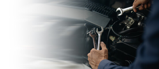 Car service, repair, maintenance concept. Auto mechanic working in garage.