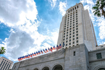 American flags on the stately facade of the City Hall skyscraper in Los Angeles