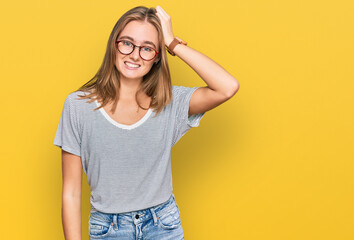 Beautiful young blonde woman wearing casual clothes and glasses confuse and wonder about question....