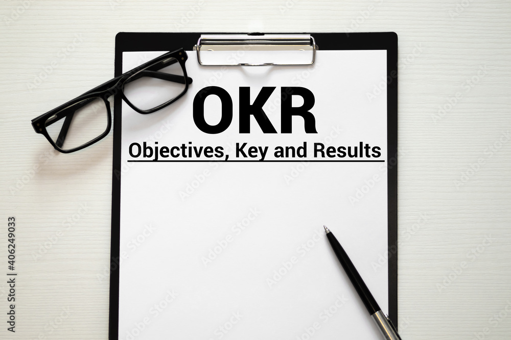 Poster objective key results okr text in the office notebook. view from above.