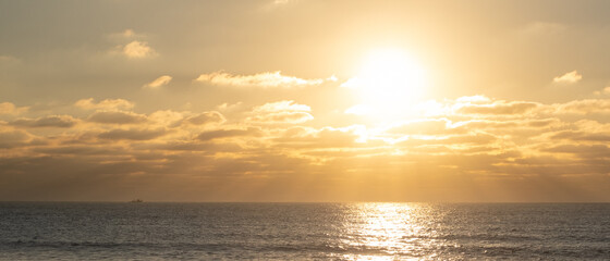 Sun reflected on ocean at sunset on the beach