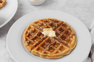 Close-up of Homemade Pecan Waffles with Butter and Syrup