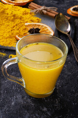 Curcuma (turmeric) spice , curcuma cocktail served with dry oranges at black table. Food and cuisine ingredients. healthy concept. . close up