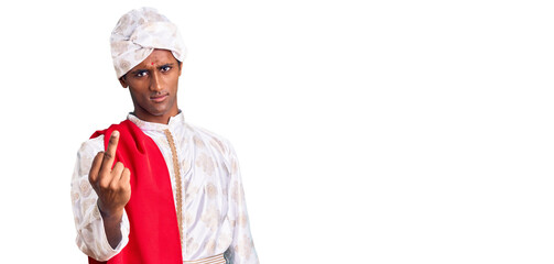 African handsome man wearing tradition sherwani saree clothes showing middle finger, impolite and rude fuck off expression