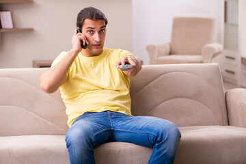 Young man student boring at home during pandemic