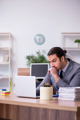 Young male employee working in the office