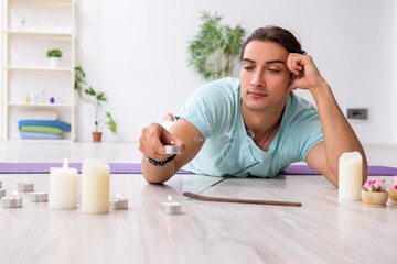 Young man during yoga session at home