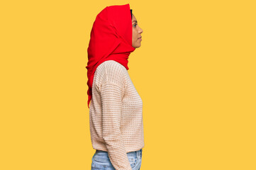 Young african american woman wearing traditional islamic hijab scarf looking to side, relax profile...