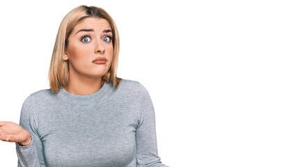 Young caucasian woman wearing casual clothes clueless and confused expression with arms and hands raised. doubt concept.