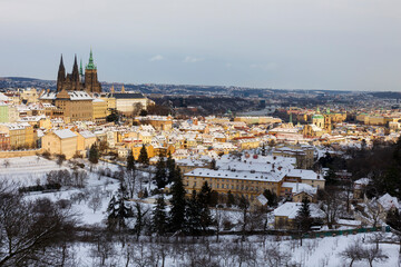 Snowy Prague City with gothic Castle from Hill Petrin in the sunny Day, Czech republic
