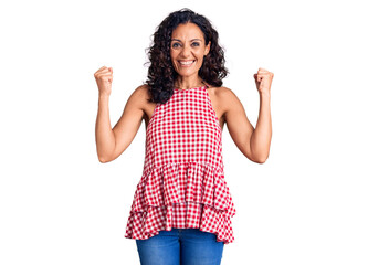Middle age beautiful woman wearing casual sleeveless t shirt screaming proud, celebrating victory...