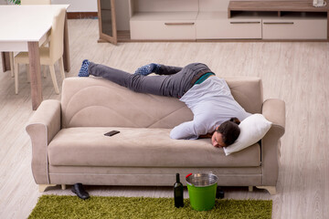 Young drunk man suffering at home