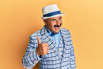 Mature middle east man with mustache wearing vintage and elegant fashion style doing happy thumbs up gesture with hand. approving expression looking at the camera showing success.