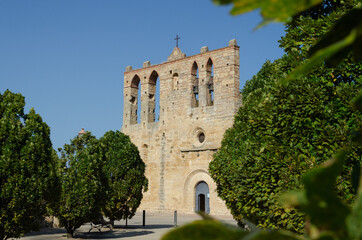 Peratallada church in a sunny day. Church of Sant Esteve in Peratallada, Catalonia. Medieval stone church in Forallac, Girona. 
