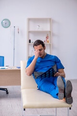 Young male doctor radiologist being unhappy after night shift