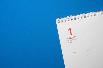 close up of calendar on the blue table background, planning on 1 january 2021 for business meeting or travel planning concept
