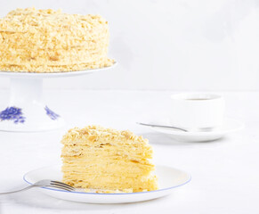 Napoleon Cake on a white plate. Traditional French dessert. Cake Napaleon of puff pastry on white background