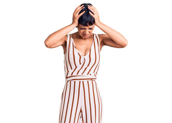Young brunette woman with short hair wearing summer outfit suffering from headache desperate and stressed because pain and migraine. hands on head.