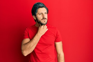 Young hispanic man wearing casual red t shirt touching painful neck, sore throat for flu, clod and infection