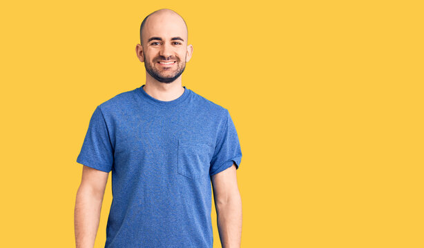 Young handsome man wearing casual t shirt with a happy and cool smile on face. lucky person.