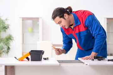 Young male carpenter working indoors