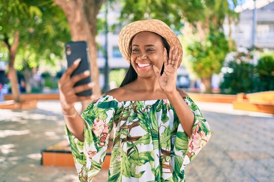 Young african american tourist woman on vacation smiling happy doing video call using smartphone at the city.