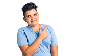 Little boy kid wearing sports workout clothes cheerful with a smile of face pointing with hand and finger up to the side with happy and natural expression on face