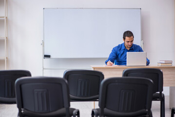 Young male business trainer making presentation during pandemic